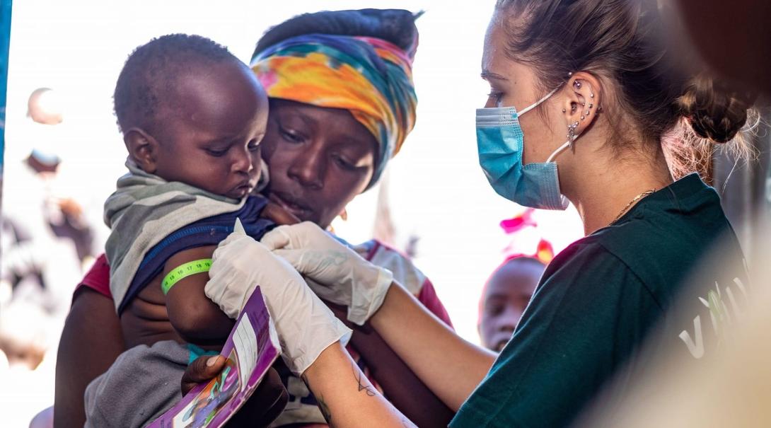 Medical intern, Devon, helps a child in Kenya Medical intern helping children in Kenya